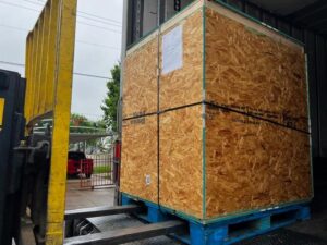 1691 Large wooden shipping crate on pallet being loaded, custom crating and packaging services in Fort Worth