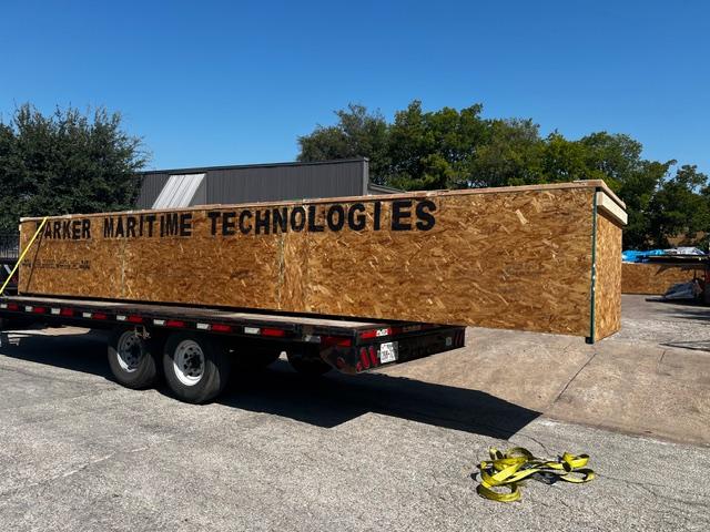 Parker Maritime Technologies wood crate on flatbed showcasing custom crating and shipping services in Fort Worth