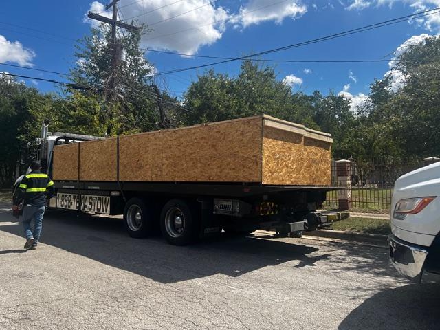 Large wooden shipping crate on pallet being loaded, custom crating and packaging services in Fort Worth