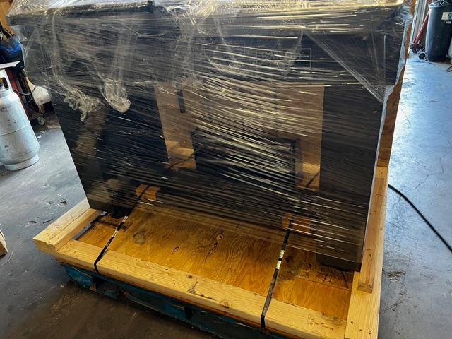 Large wooden shipping crate on pallet being loaded, custom crating and packaging services in Fort Worth