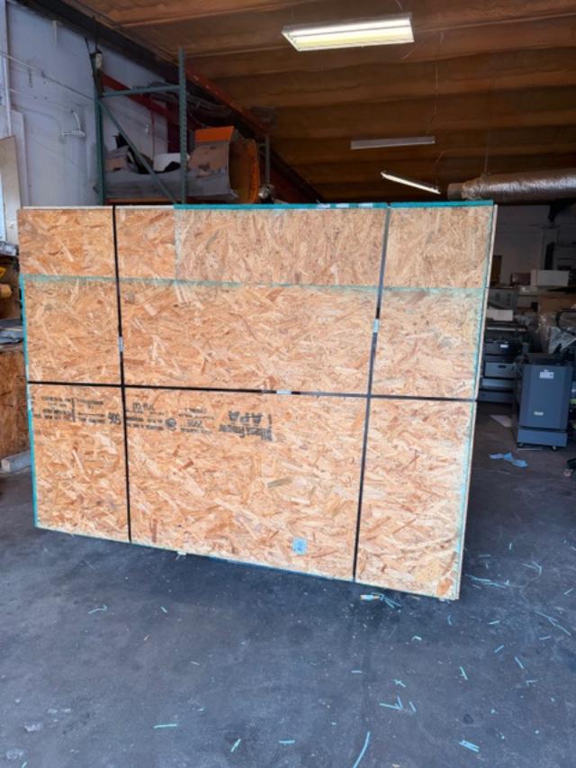 Large wooden shipping crate on pallet being loaded, custom crating and packaging services in Fort Worth
