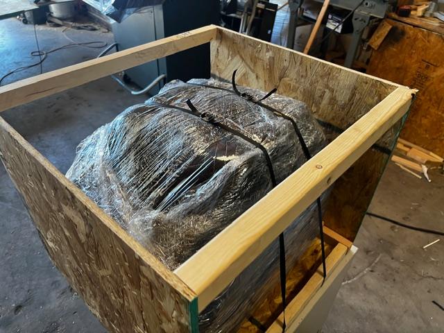 Large wooden shipping crate on pallet being loaded, custom crating and packaging services in Fort Worth