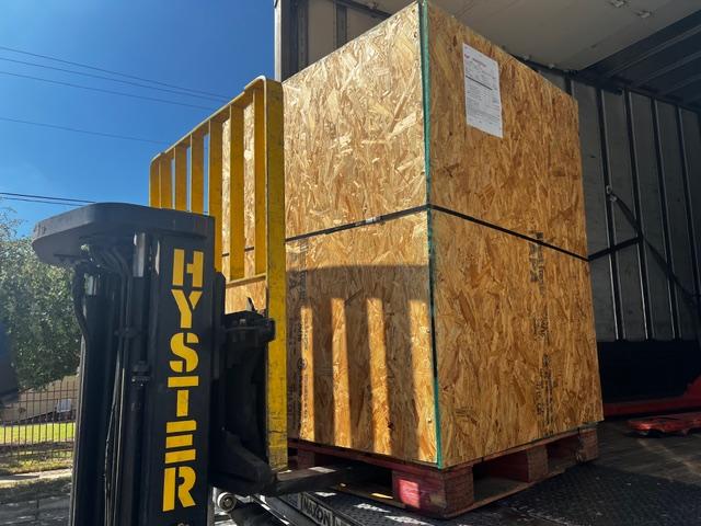 Parker Maritime Technologies wood crate on flatbed showcasing custom crating and shipping services in Fort Worth