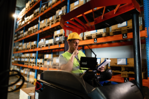 indian-man-working-male-yellow-vest-man-near-tractor 1 Large wooden shipping crate on pallet being loaded, custom crating and packaging services in Fort Worth