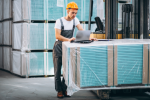 industrial-worker-indoors-factory-young-technician-with-orange-hard-hat 1 Parker Maritime Technologies wood crate on flatbed showcasing custom crating and shipping services in Fort Worth